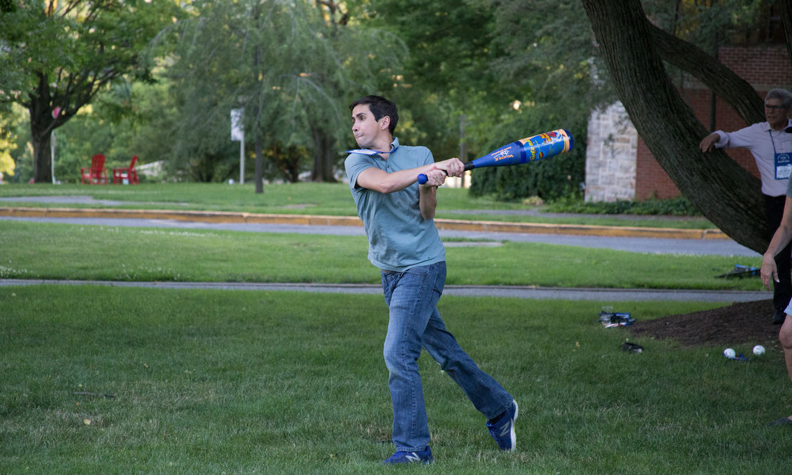 Santiago Toledo swings for the fences during opening night wiffleball.